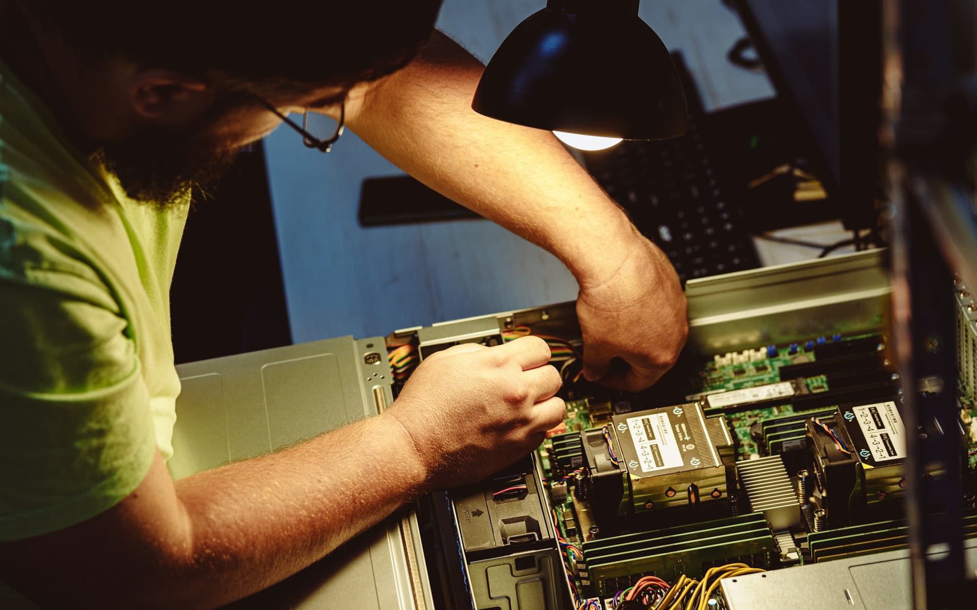 Male field technician repairing server hardware