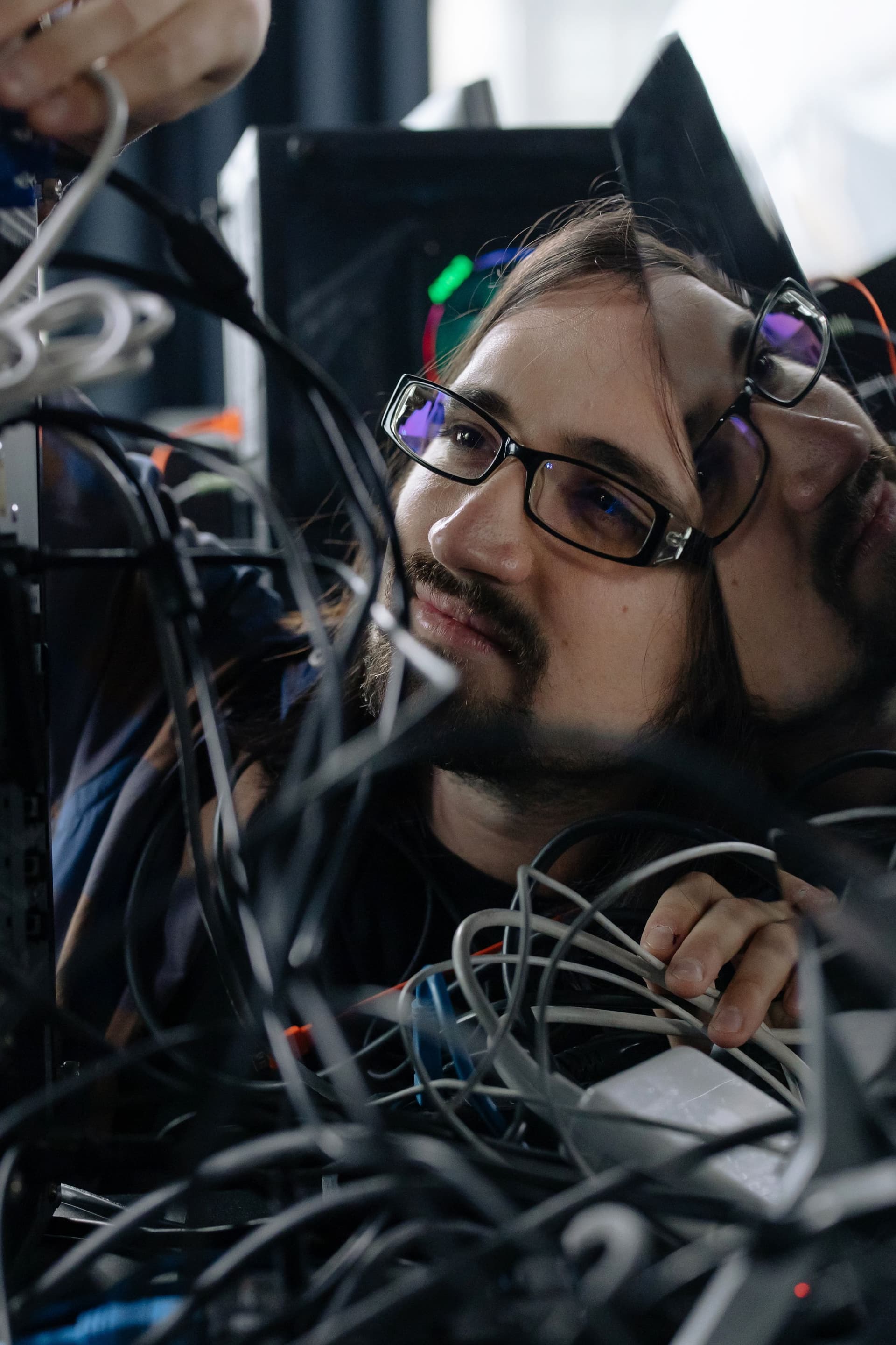 Technician inspecting cables and equipment at close range